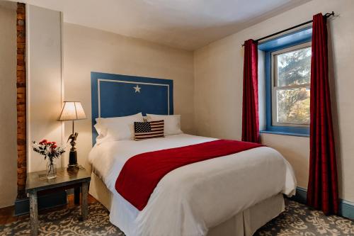a bedroom with a large bed and a window at Galvanized America Inn & Art Gallery in Doylestown