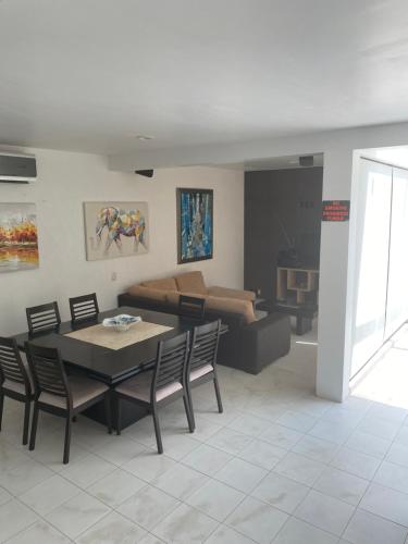 a living room with a table and a couch at VILLA ACAPULCO DIAMANTE in Acapulco