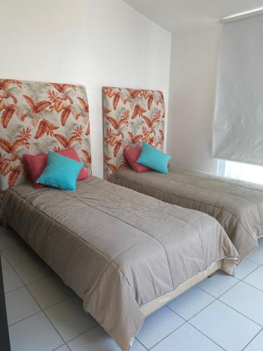 two beds sitting next to each other in a room at VILLA ACAPULCO DIAMANTE in Acapulco