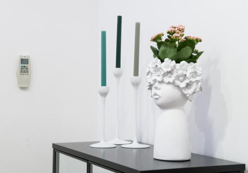 een tafel met twee vazen met bloemen en kaarsen bij Loft del Teatro in Siracusa