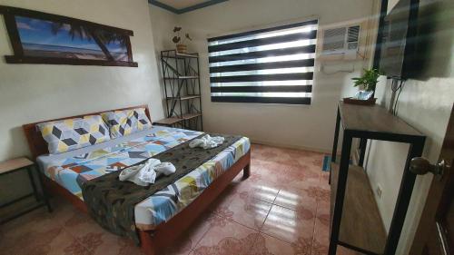 a bedroom with a bed with towels on it at UNK'S HOUSE HOMESTAY in Panglao