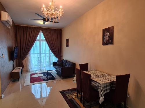 a living room with a dining room table and a chandelier at Eid SKS Habitat -Free Wifi Netflix, Larkin, Johor Bahru in Johor Bahru