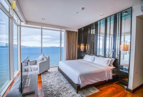 a bedroom with a bed and a view of the ocean at The Costa Nha Trang Residences in Nha Trang