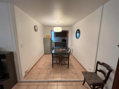 a dining room and kitchen with a table and chairs at Maison au coeur de la rue pietonne in Saint-Jean-Pied-de-Port