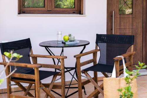 two chairs and a small table with an apple on it at Olea Suites in Gouves