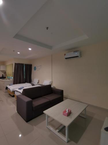 a living room with a couch and a table at Rustic one bedroom unit for 4pax by Jomy Management in Lumut