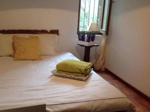 a bedroom with a bed with a green blanket on it at Casa Rural Saint Joseph in Peralejo