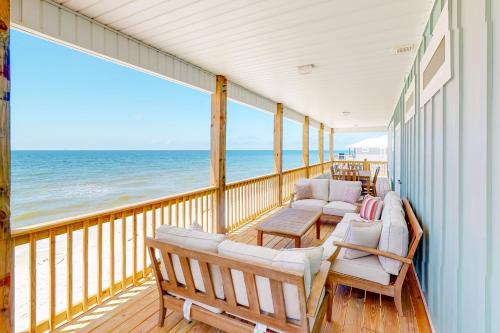 a balcony with chairs and a view of the ocean at On Deck in Dauphin Island