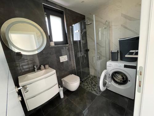 a bathroom with a sink toilet and a mirror at Vila Softic Amra in Umag