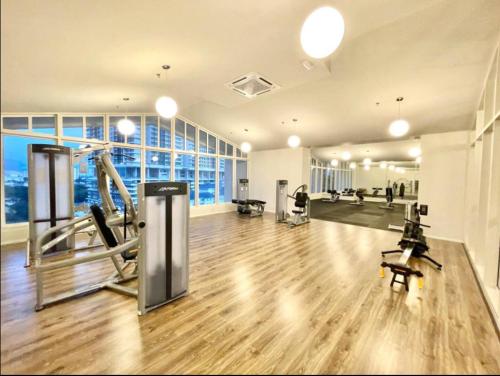 a gym with exercise equipment in a large building at UNA Sunway Velocity Kuala Lumpur by Unimax in Kuala Lumpur
