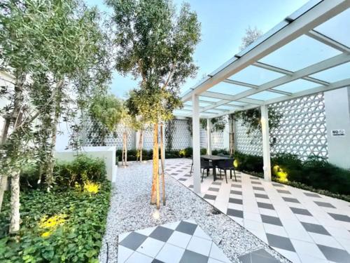 an outdoor patio with a pergola and trees at UNA Sunway Velocity Kuala Lumpur by Unimax in Kuala Lumpur