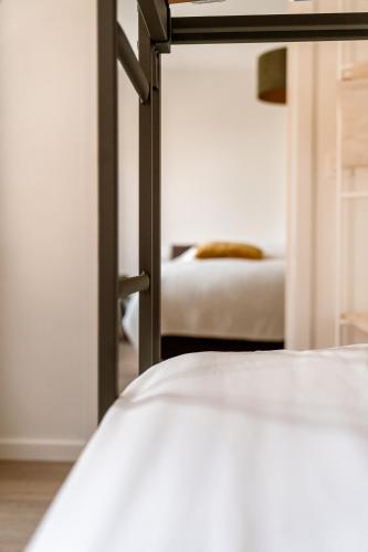 a view of a bedroom with a bed and a mirror at La Damme in Damme