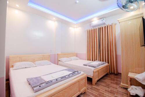 um quarto com 2 camas e um tecto azul em 75 MOTEL em Ha Giang