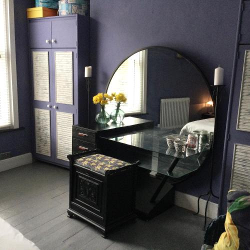 a room with a mirror and a desk and a table at The ArtWorks in Hastings