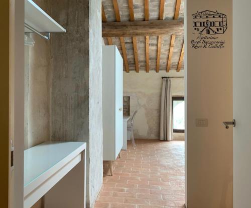 a hallway of a house with a brick floor at Agriturismo Borgo Buzzaccarini Rocca di Castello in Monselice