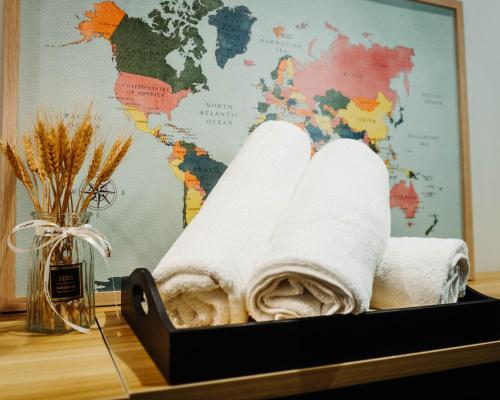 a tray of rolled towels on a table with a map at UNA Sunway Velocity Kuala Lumpur by Unimax in Kuala Lumpur