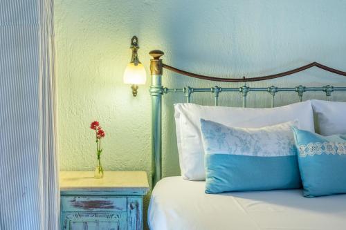 a bedroom with a bed and a vase of flowers on a night stand at Irida Apartments in Stafylos