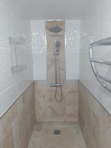 a shower with a glass door in a bathroom at Gîte, suite d'hote de charme, petit déjeuner compris in Firmi