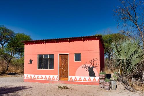 a small house with a painting on the side of it at Semowi Lodge and Campsites in Mirapene