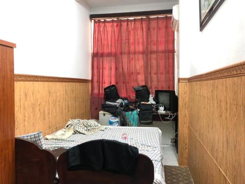 a room with a bed and a table and chairs at North Hostel N.2 in Hanoi