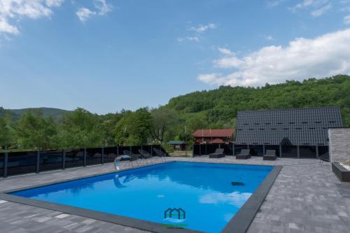 a swimming pool on the roof of a house at Holiday Houses Green Queen in Bihać