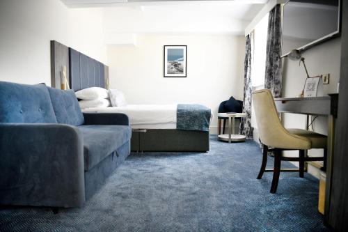a living room with a couch and a bed at Dover Marina Hotel & Spa, Tapestry Collection by Hilton in Dover