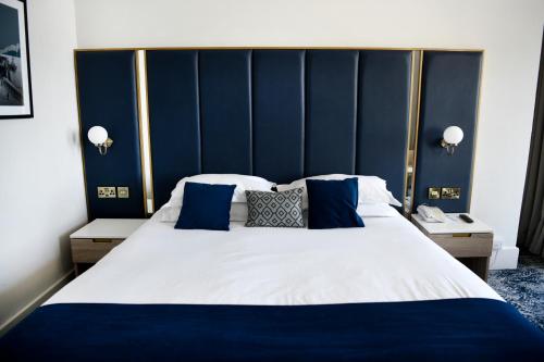 a bedroom with a large bed with blue walls at Dover Marina Hotel & Spa, Tapestry Collection by Hilton in Dover