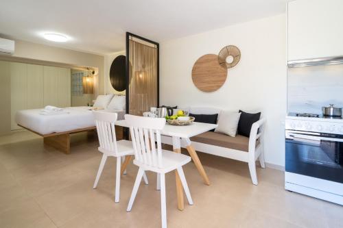 a kitchen and living room with a table and chairs at Olea Suites in Gouves