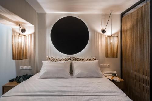 a bedroom with a large bed with a black mirror at Olea Suites in Gouves