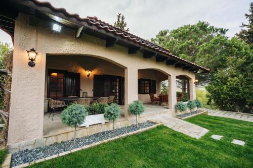 a house with a patio and a yard at The Tree House in Áyios Andréas