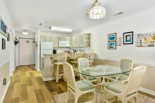 a kitchen and dining room with a glass table and chairs at Harbour Club 12G in Ocean City