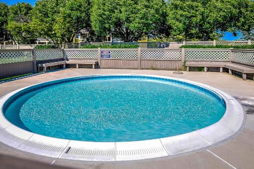a large swimming pool with two benches around it at Harbour Club 12G in Ocean City
