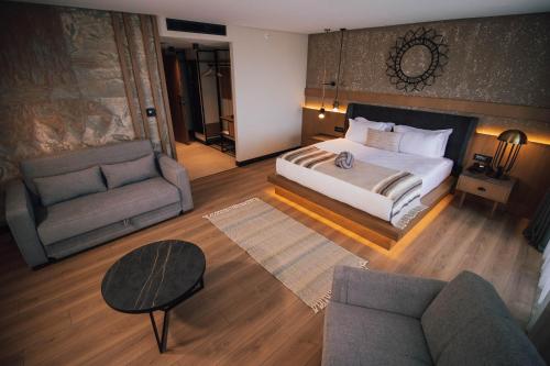 a large bedroom with a bed and a couch at Panagia Premier Trabzon in Trabzon