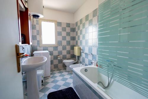 a bathroom with a sink and a tub and a toilet at Bianca Casa in Bolognetta