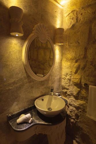 a bathroom with a sink and a mirror at Solo Cave Suites in Nevsehir