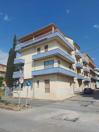 a large apartment building with a stop sign in front of it at Vincenti's House Comiso in Comiso
