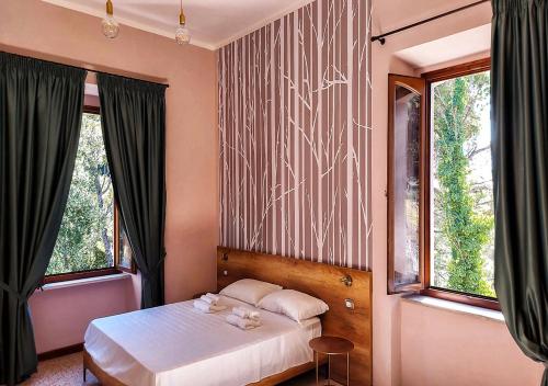 a bedroom with a bed with two stuffed animals on it at Ostello Ossigeno in Campodimele