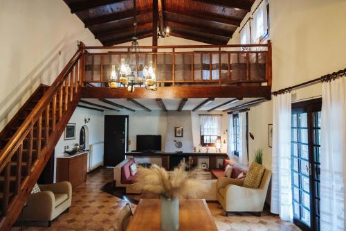 a living room with a staircase and a living room at The Tree House in Áyios Andréas