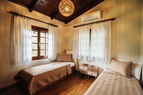 a bedroom with two beds and a window at The Tree House in Áyios Andréas