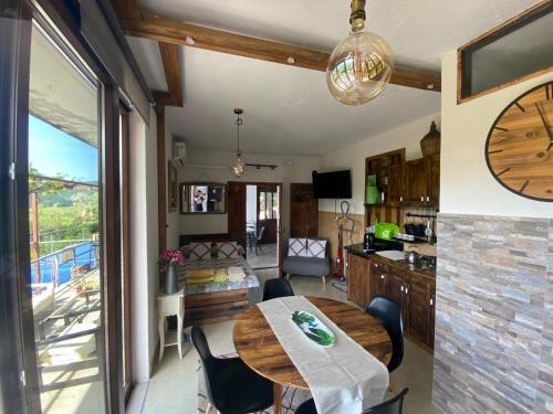a kitchen and dining room with a large clock on the wall at Apartman Verona Buzet in Buzet
