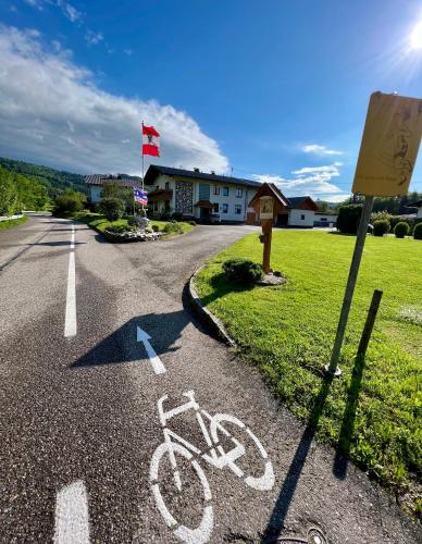 a bike parked on the side of a road at BacherlHouse - Apt Miglbach in Schörfling