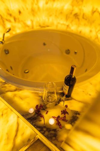 a bottle of wine and a glass in a sink at Solo Cave Suites in Nevsehir