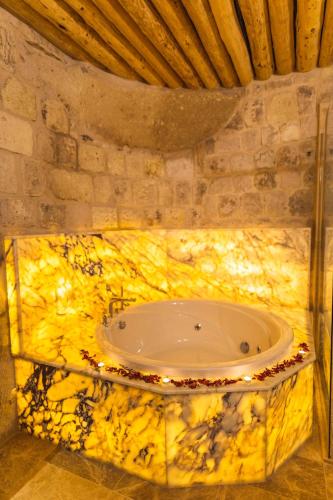 a bathroom with a tub with lights in it at Solo Cave Suites in Nevsehir