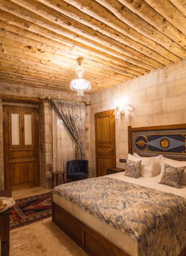 a bedroom with a bed and a wooden ceiling at Solo Cave Suites in Nevsehir