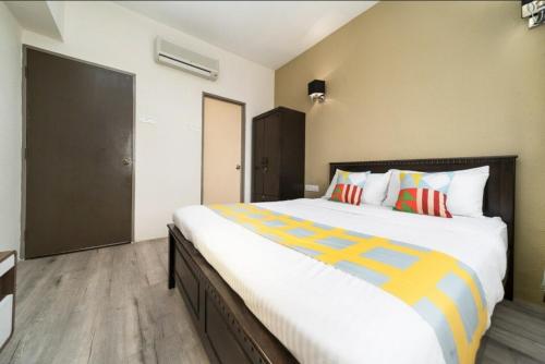 a bedroom with a large bed with colorful pillows at Deluxe VIP Seaview Batu Ferringhi 1503 - 3 Rooms in Batu Ferringhi