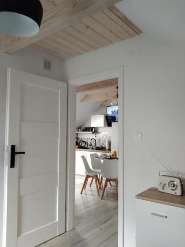 a room with a door leading into a kitchen at Apartamenty Równia 2 in Ustrzyki Dolne