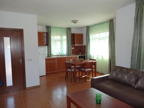 a living room with a couch and a table at Guest House Ivanini Houses in Tryavna