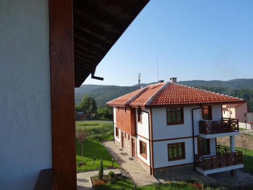 a view of a house from a window at Guest House Ivanini Houses in Tryavna