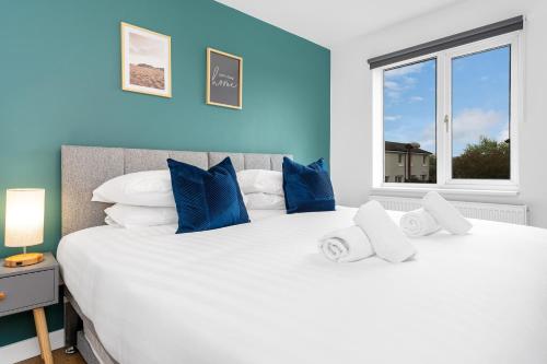 a large white bed in a room with a window at Cheerful Stays - Livingston - 4 Bedroom 3 Bath home in Livingston