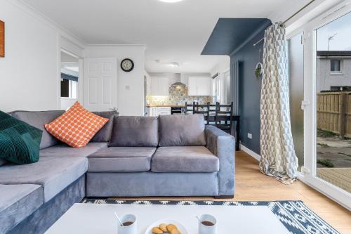 a living room with a couch and a table at Cheerful Stays - Livingston - 4 Bedroom 3 Bath home in Livingston